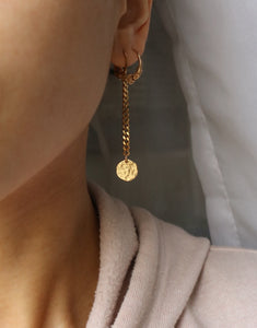 Photo portée des boucles d'oreilles Bérénice, bijoux en acier inoxydable de la marque Tan Tao. 